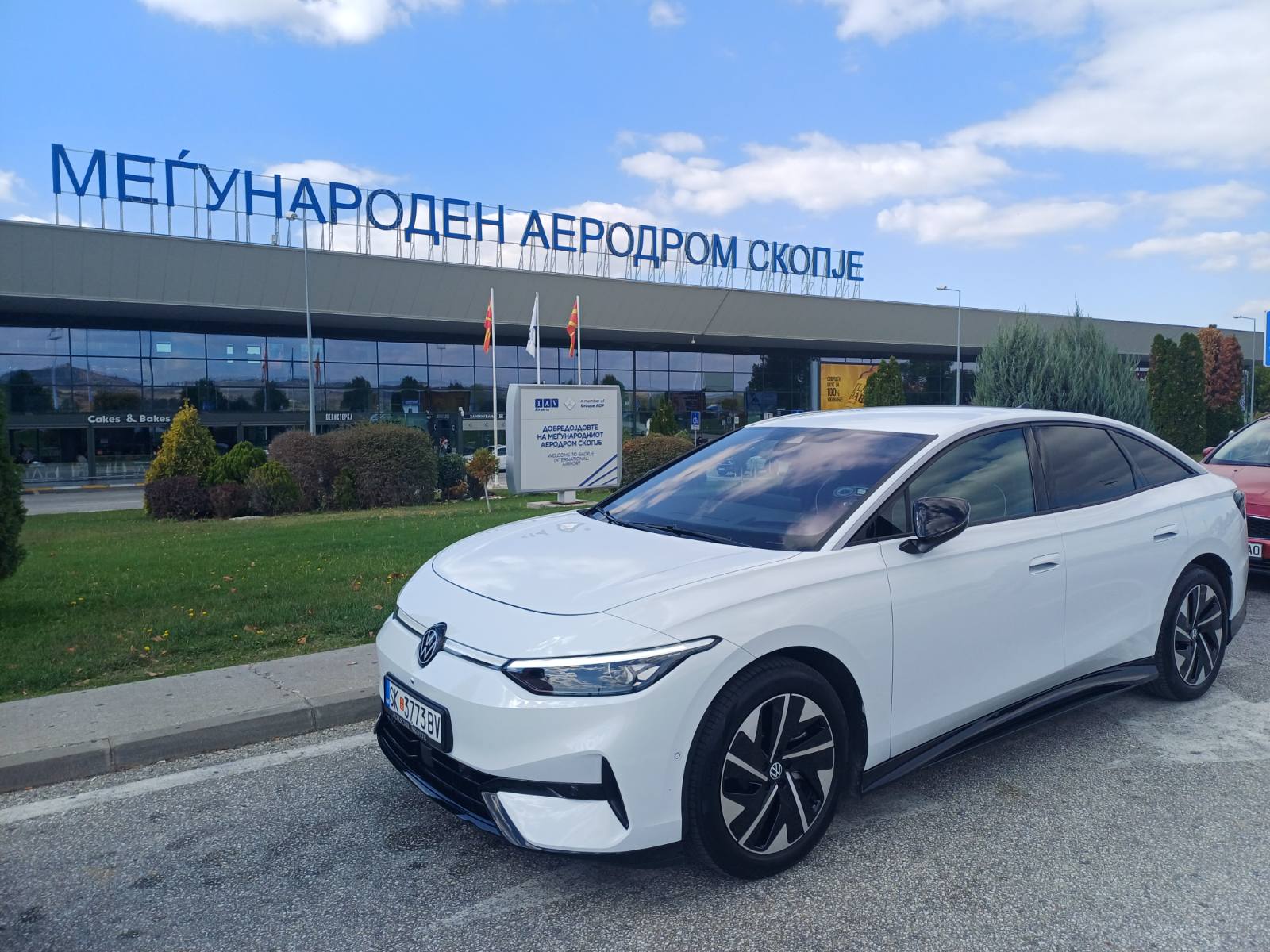 White VW ID.7 electric car in front of Skopje International Airport